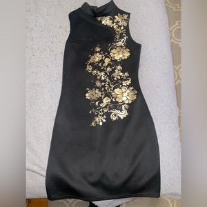 black dress with gold detailing and a sheer cut out, size M